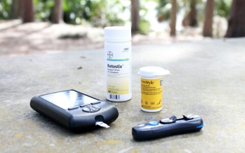black smartphone beside white plastic bottle and black smartphone