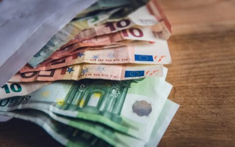 euro banknote collection on wooden surface