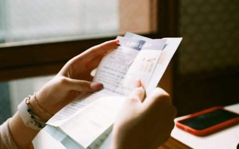 person holding white printer paper