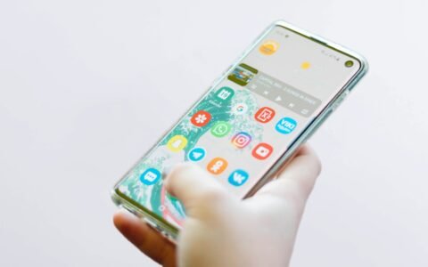 person using silver Android smartphone